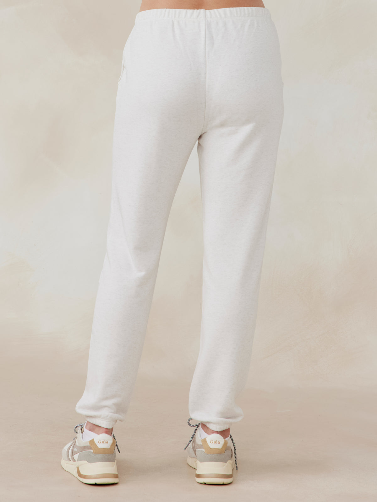 Light gray Stadium French Terry sweatpants with elastic waistband and cuffs, shown from the back worn by a model tasc performance stadium sweatpant (CoconutHeather)