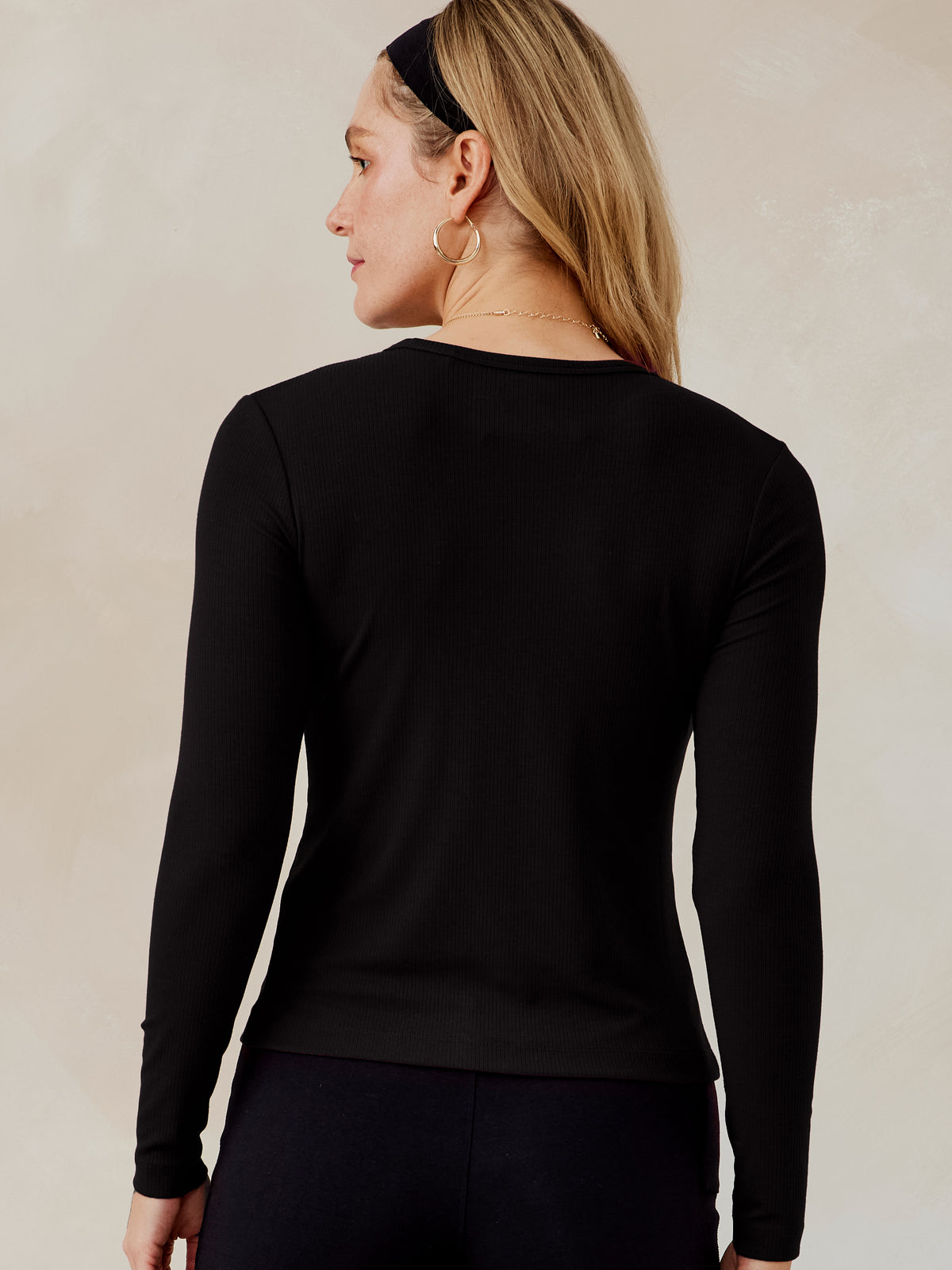 Woman wearing a black microluxe rib long sleeve top shown from the back with a round neckline and fitted sleeves tasc Microluxe Rib LS (Black)