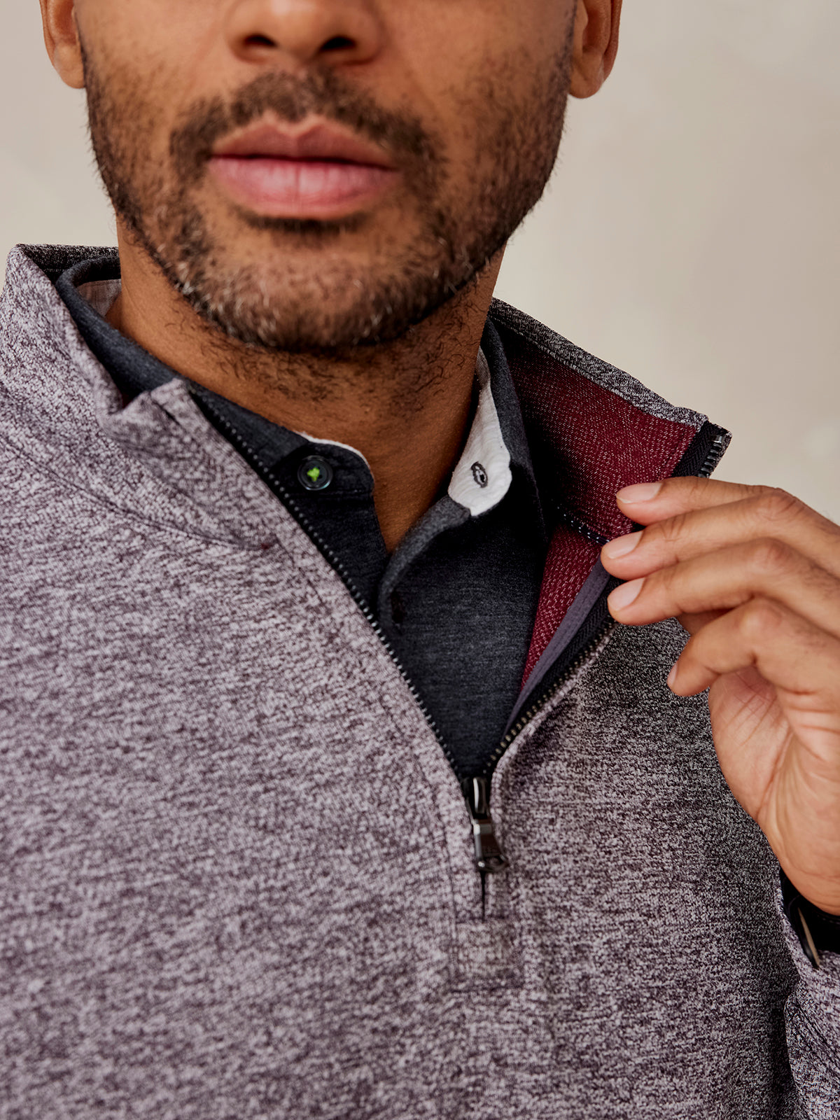 Man wearing a marled gray Crest Jacquard quarter zip sweater with a burgundy inner collar and black shirt underneath tasc Crest Jacquard Quarter Zip (Charcoal)