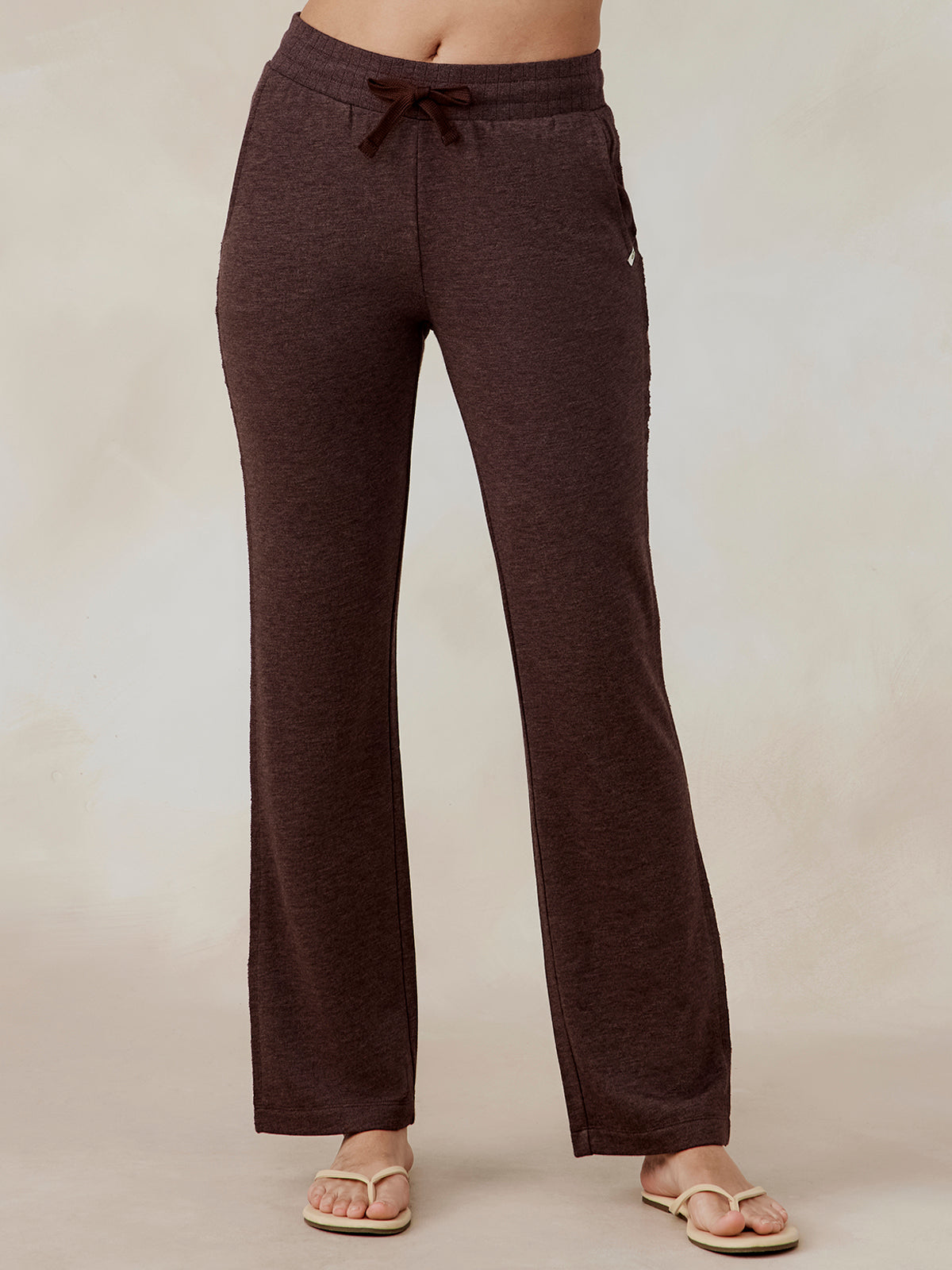 Wide leg sweatpants in dark brown French terry fabric with drawstring waist and side pockets, worn by model front view tasc Performance Stadium French Terry Wide Leg Pant (MochaHeather)