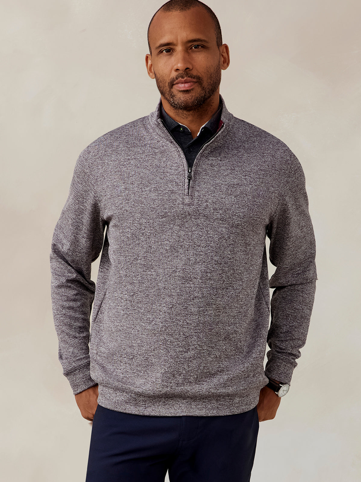 Man wearing a heather gray Crest Jacquard quarter zip pullover with a stand collar and navy pants, front view tasc Crest Jacquard Quarter Zip (Charcoal)