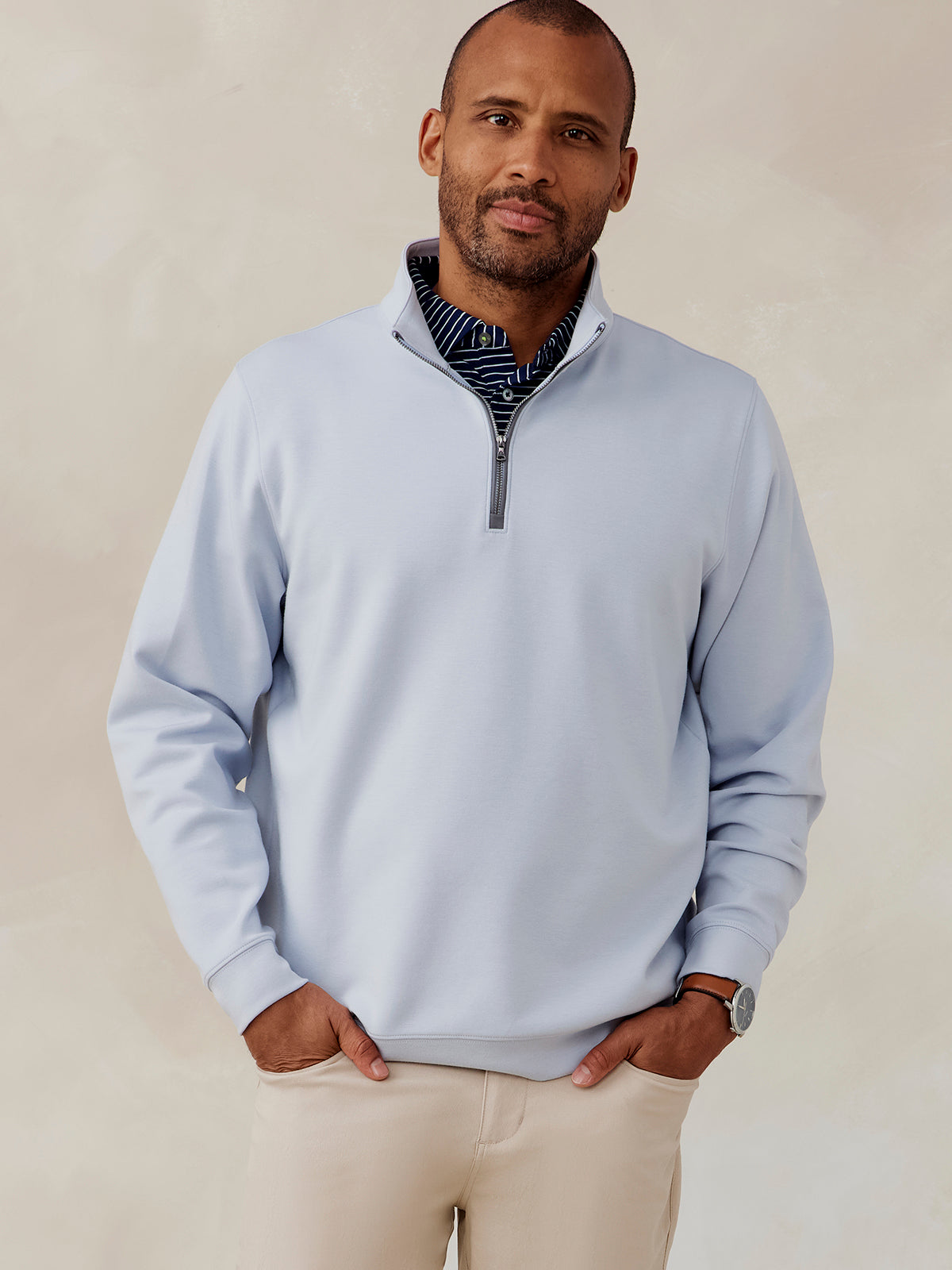 Man wearing light blue Highlands quarter zip pullover with front zipper and beige pants, front view tasc Highlands Quarter Zip (Cloud)
