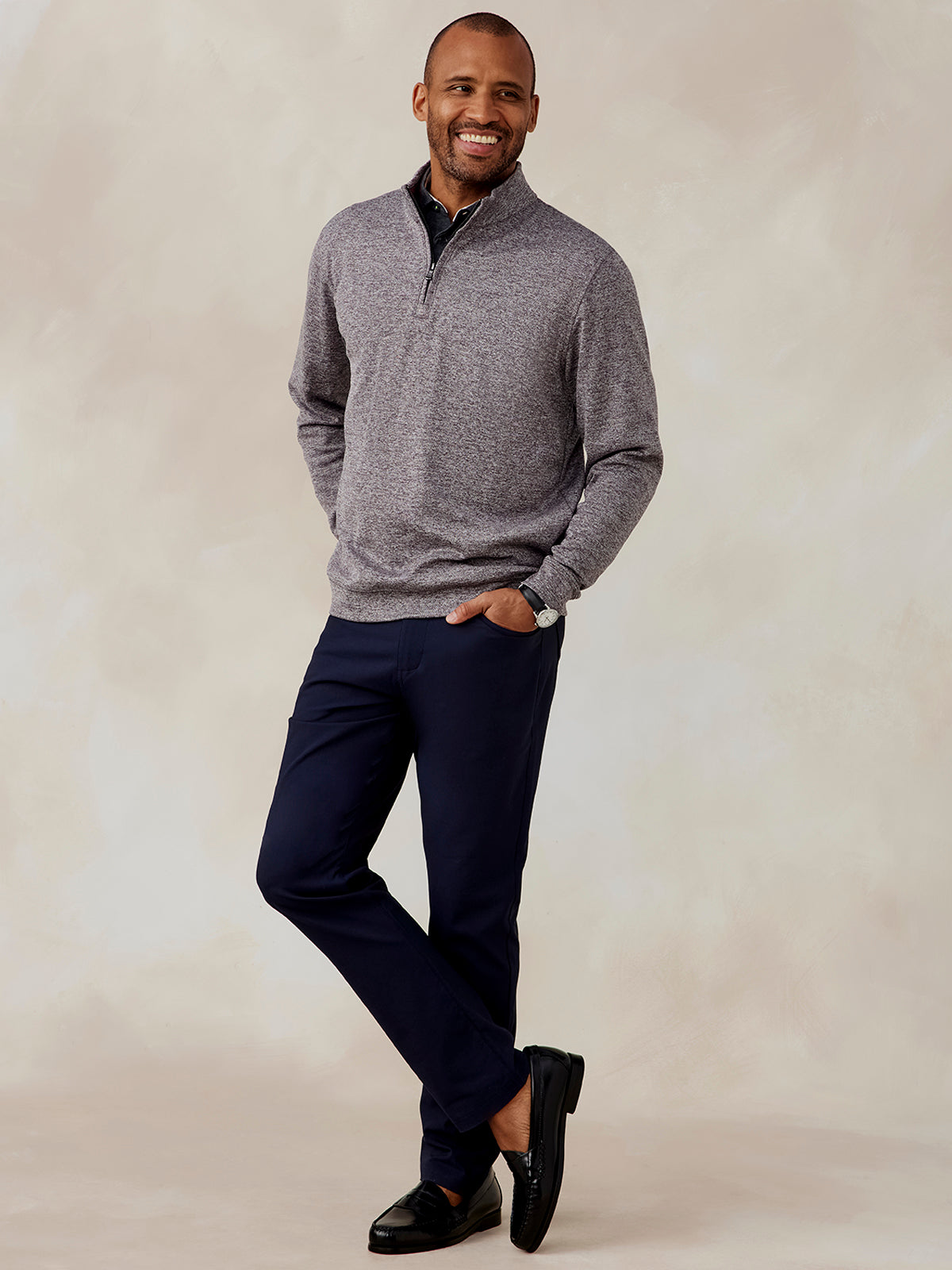 Man wearing a heather gray Crest Jacquard quarter zip pullover with navy pants and black loafers, standing with hands in pockets tasc Crest Jacquard Quarter Zip (Charcoal)