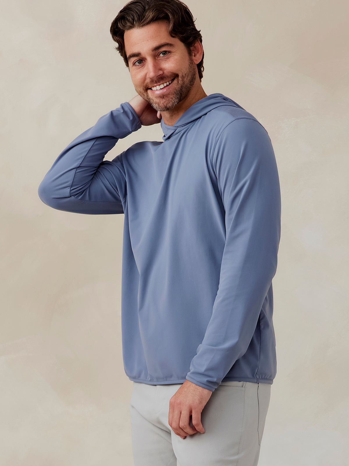Man wearing a light blue Stratford hoodie with long sleeves and a hood, shown from the side and front angle tasc Performance Stratford Hoodie (Anchor)