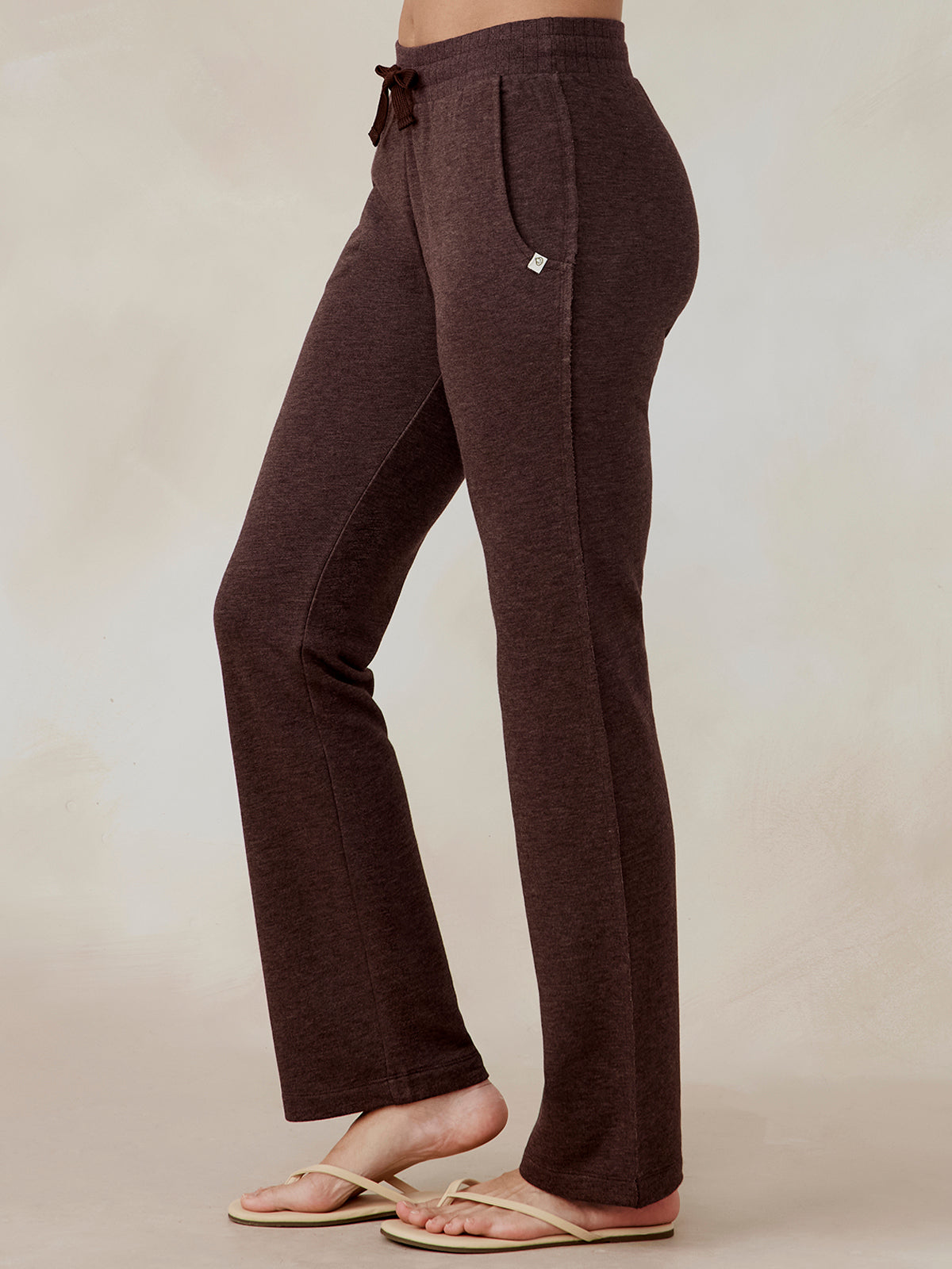 Brown French terry wide leg sweatpants with drawstring waist and side pockets, worn by model in side view tasc Performance Stadium French Terry Wide Leg Pant (MochaHeather)